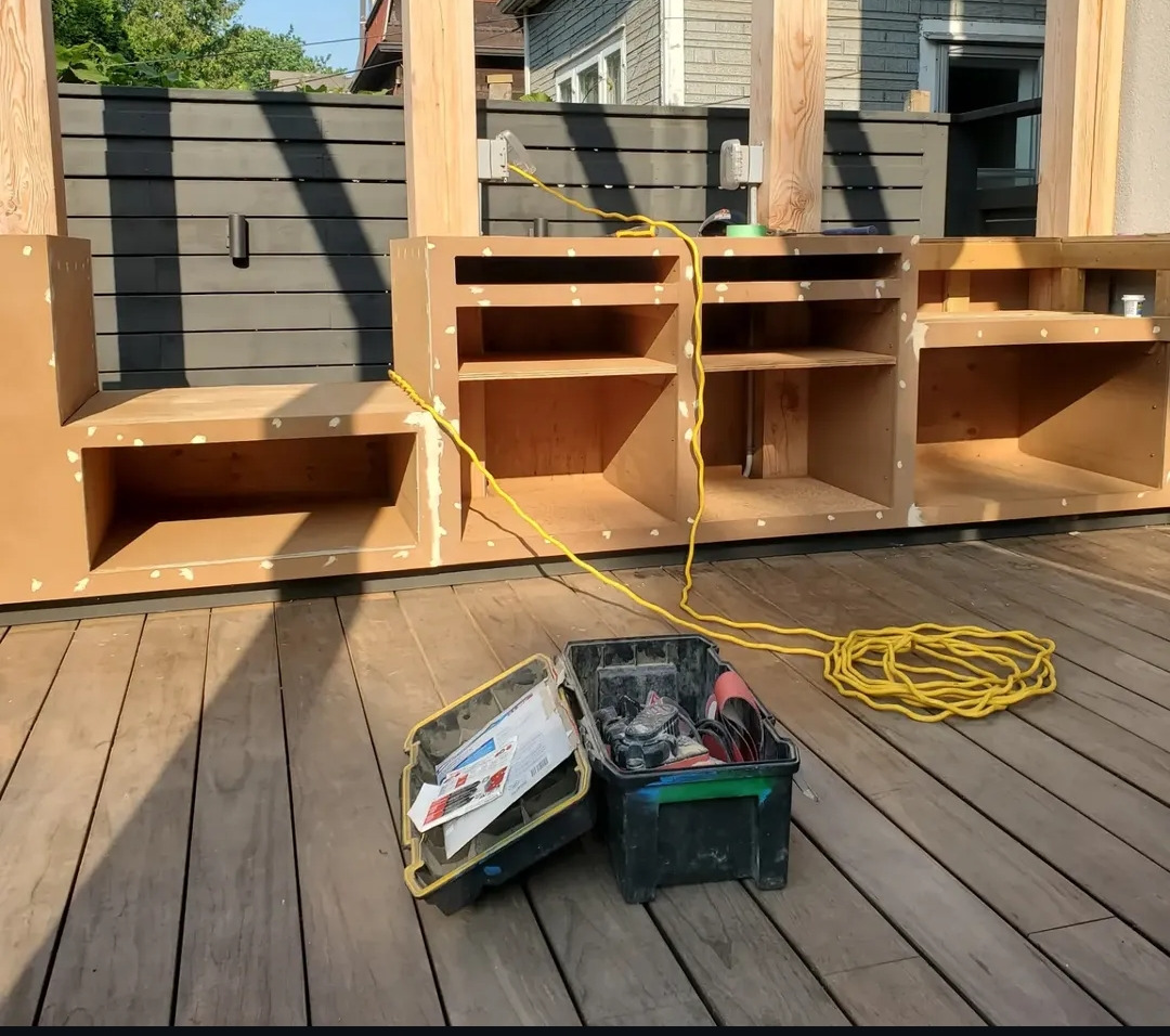 Plywood cabinet carcasses built and dry-fitted in place on the deck